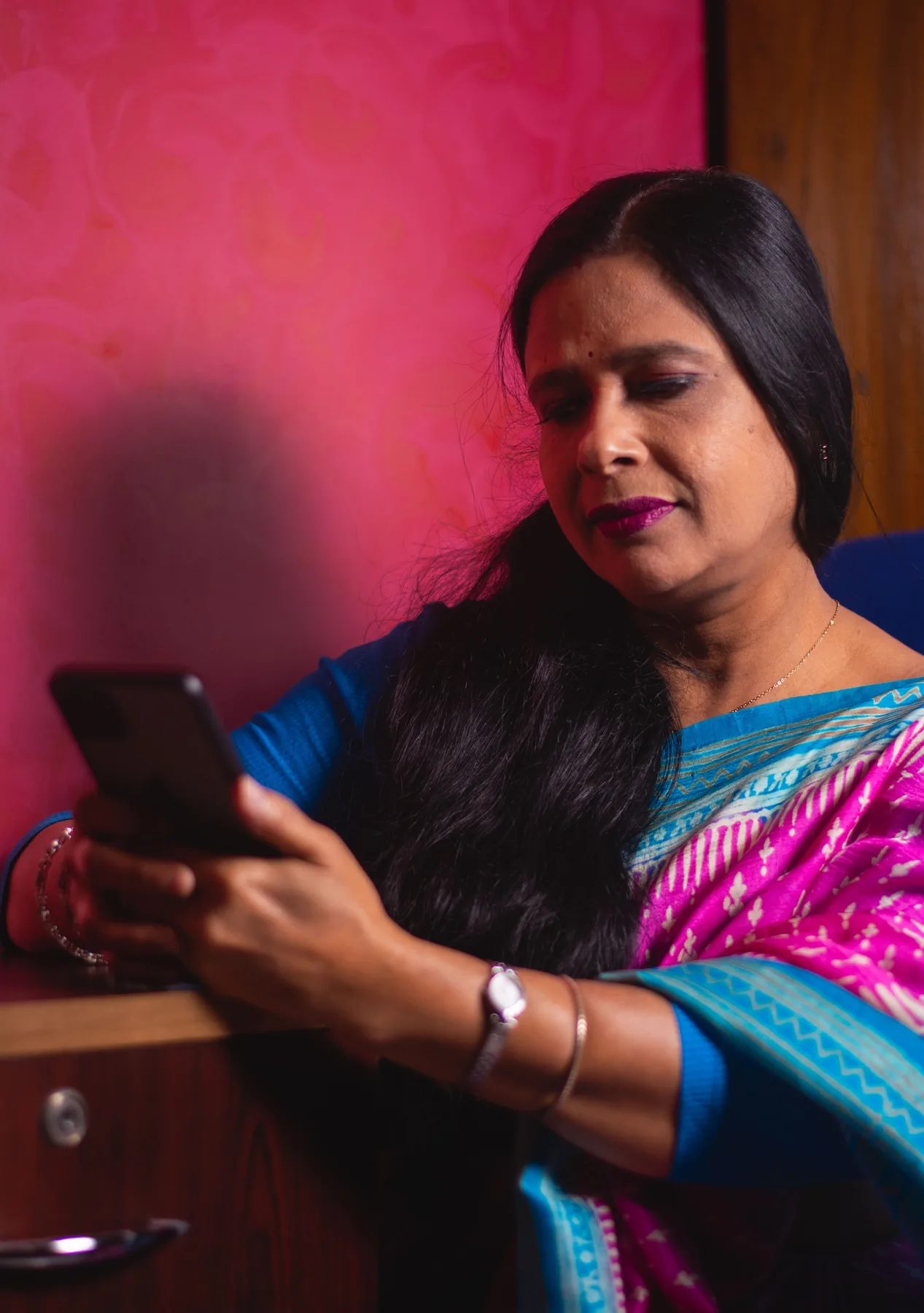 Representative Indian woman using a smartphone