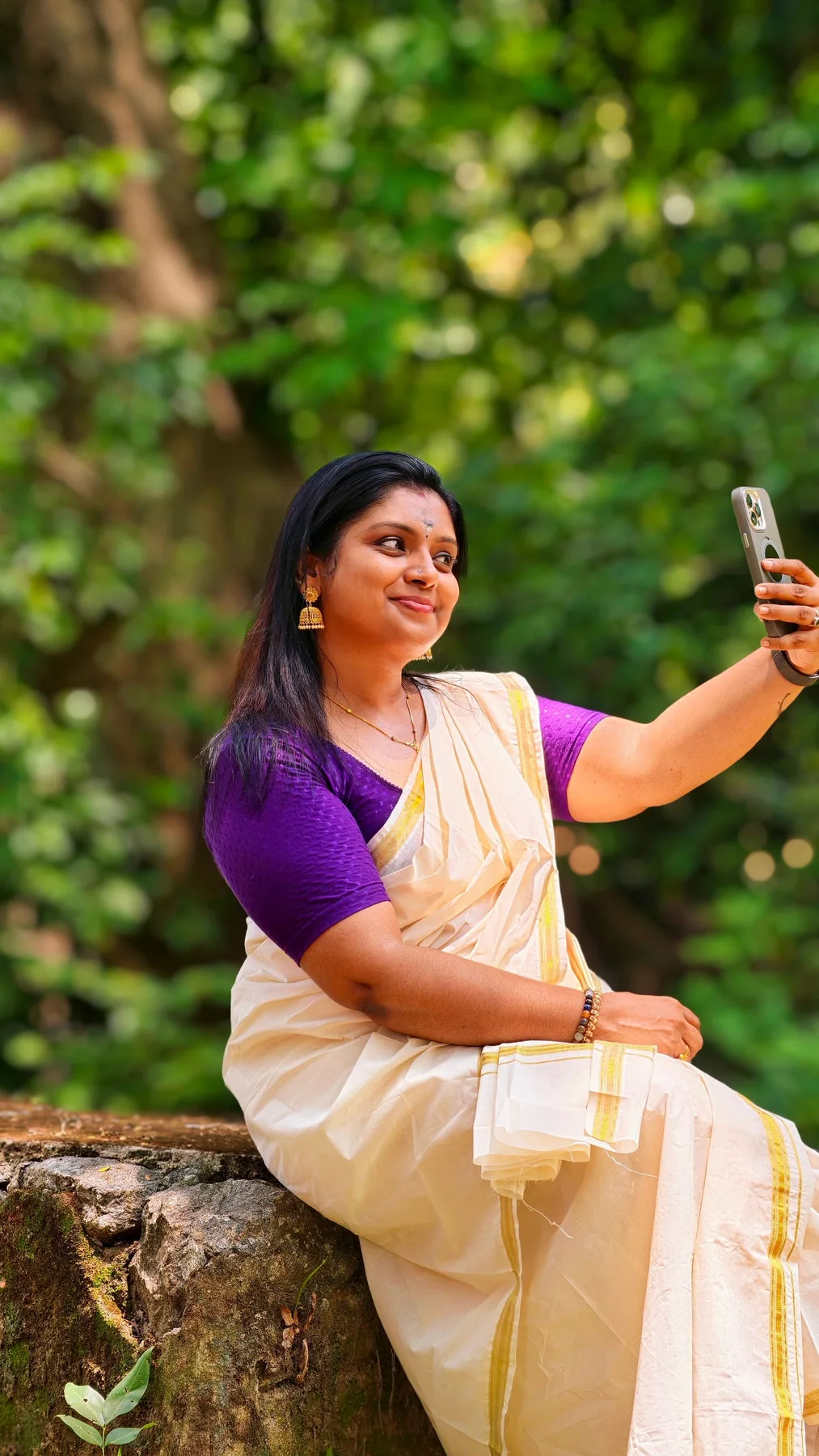 Representative Indian woman using a smartphone outdoors