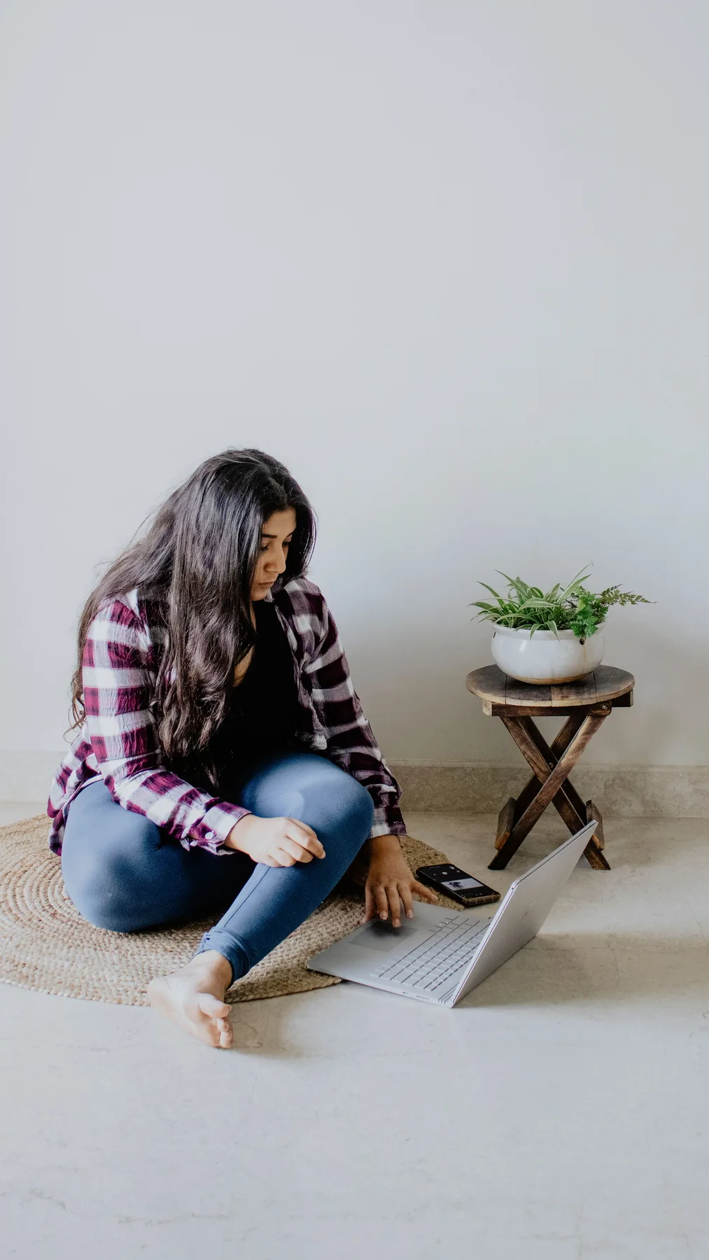 Representative Indian woman using a laptop at home