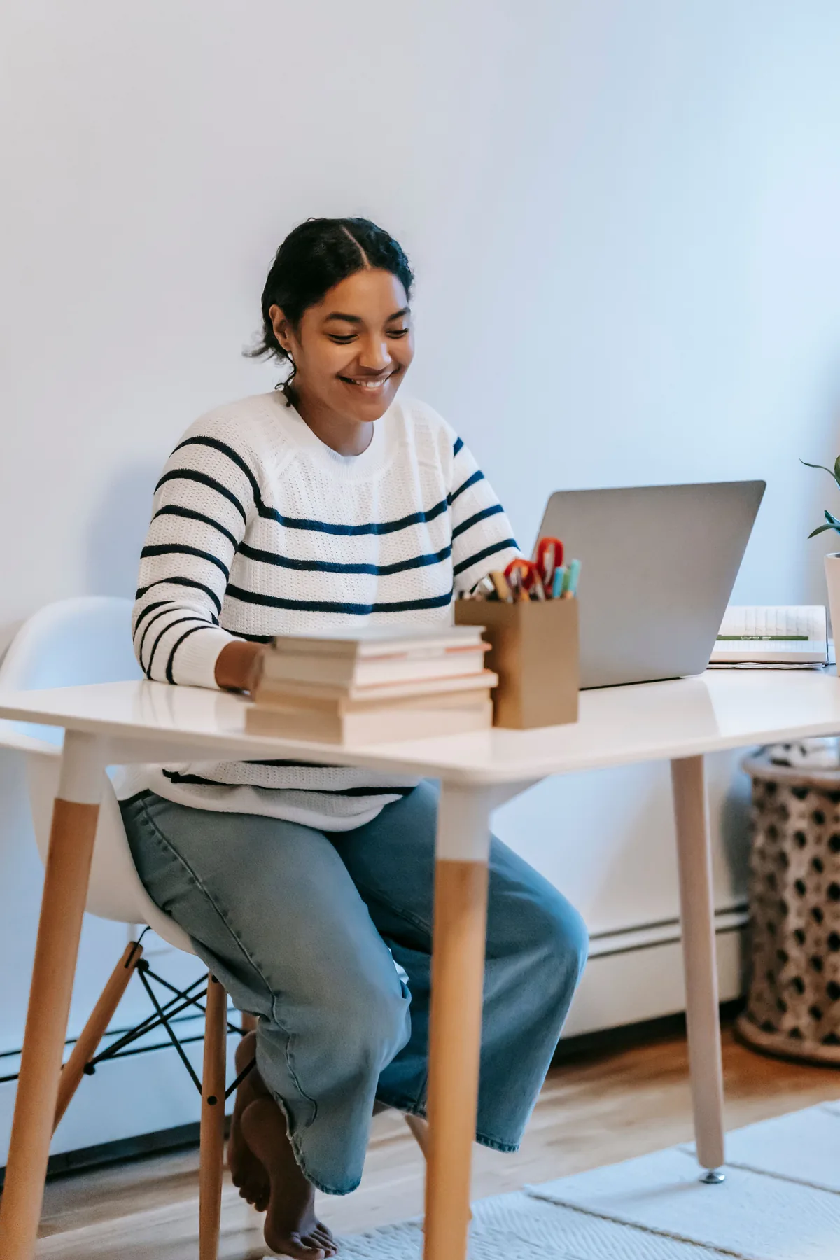 Representative woman working at a desk with a laptop
